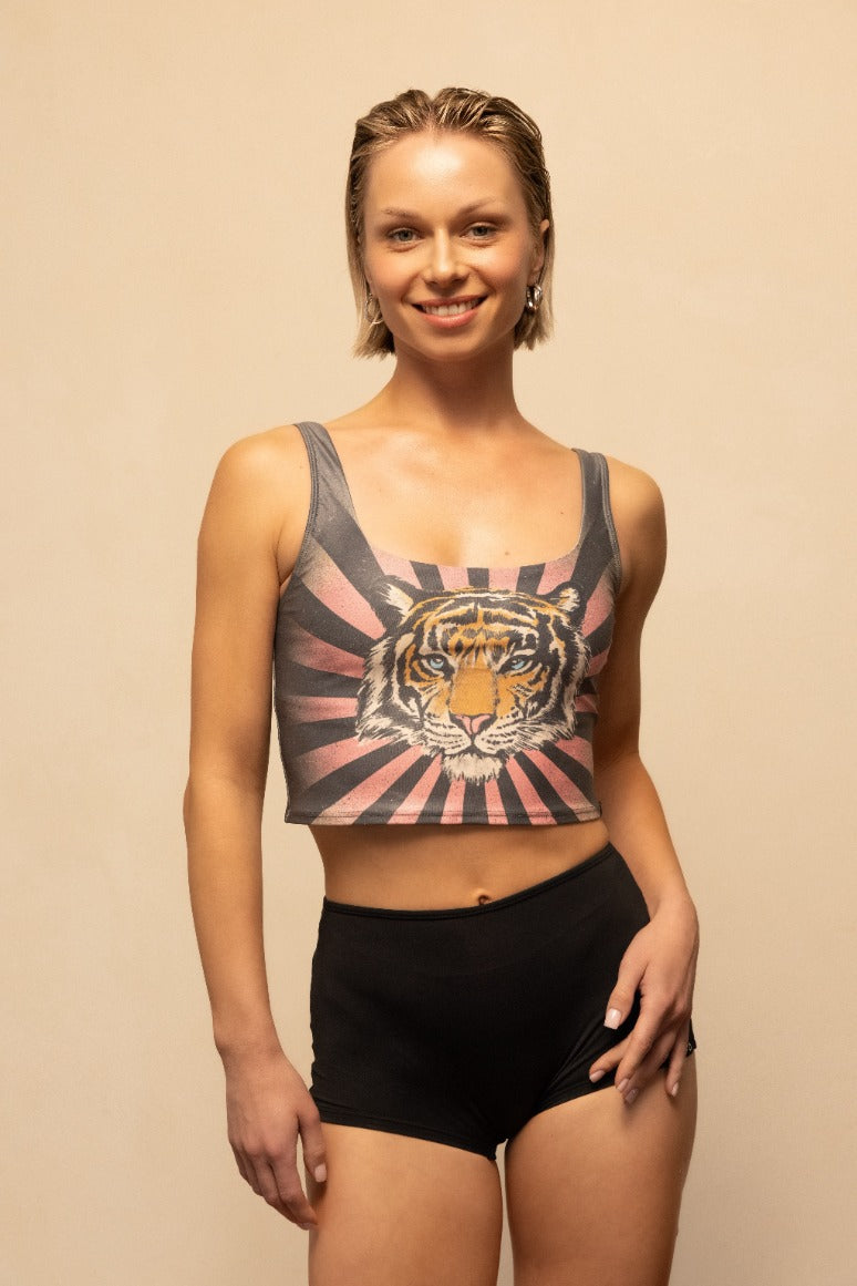 Woman wearing a tank top with a tiger design on a beige background