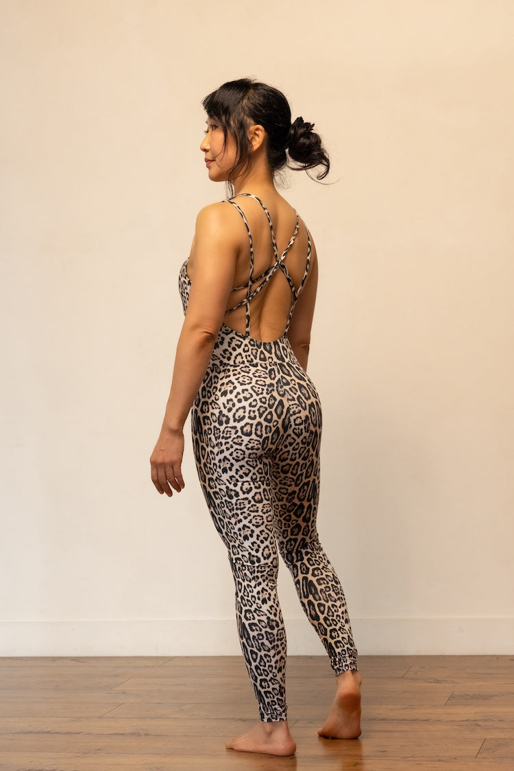 Person wearing a leopard print outfit with a plain background